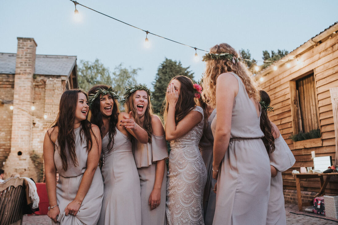 boho bridesmaids laughing together
